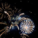 Vibrant fireworks illuminate the night sky, celebrating a festive event with bright and vivid explosions.